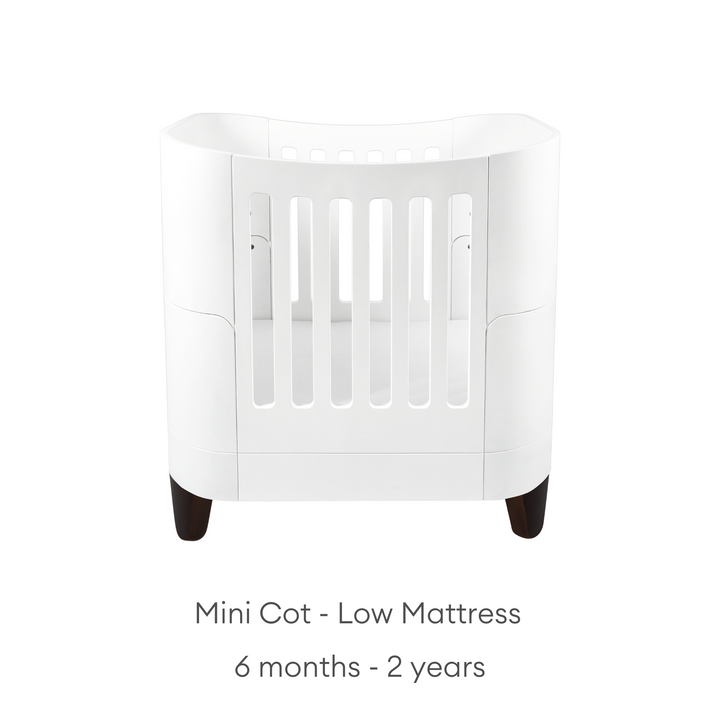 product image of Gaia baby Serena mini Cot with walnut legs showing the low mattress