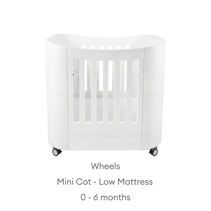 product image of Gaia baby Serena mini Cot with wheels showing the low mattress