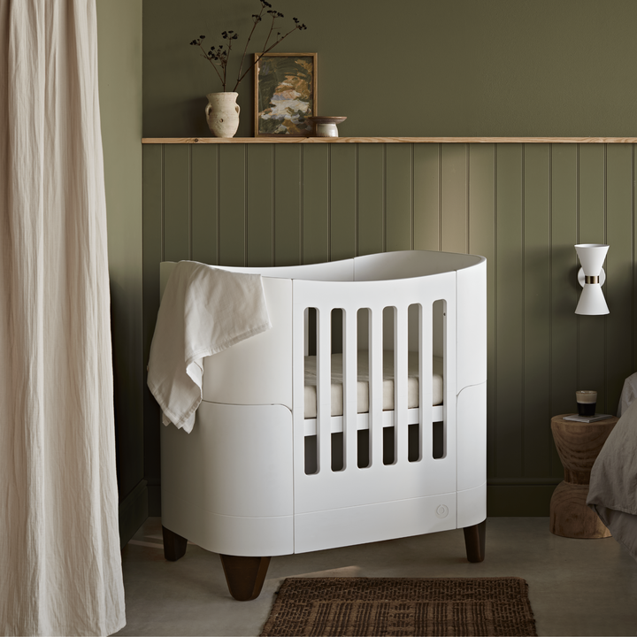 Gaia Baby Serena Mini Cot with Walnut Legs in a nursery